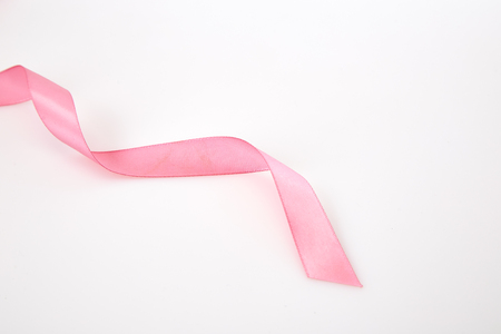 Curled pink ribbon on white background, Empty space for designの写真素材