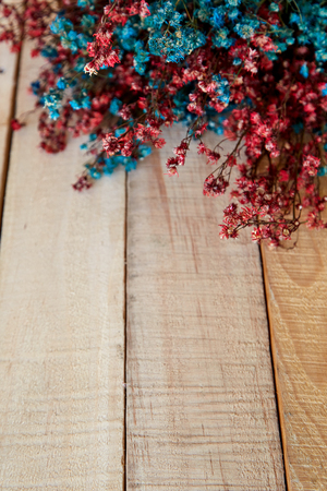 Dried color flowers spring on wooden rustic background, Space for text, overhead, flat layの写真素材