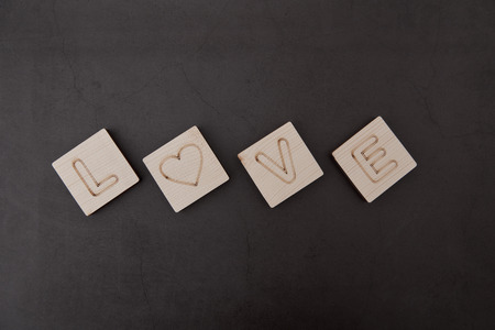 Love wooden Text dark Black Background, Valentines day. Sale banner, Photograph taken from above, top view with copy spaceの写真素材