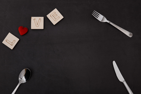 Love wooden Text dark Black Background, Valentines day. Sale banner, Photograph taken from above,...
