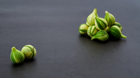 Fresh figs Bordissot Negra Rimada tree, producting its variegated and colorful fruits on dark rustic background, Flat lay. Nature concept, Free spaceの写真素材