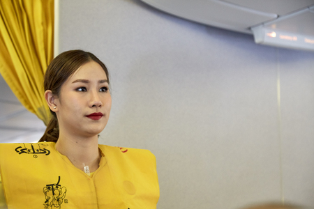 Bangkok Thailand, Jan 22 ,2019 , Airline nokscoot Interior of airplane with passengers on seats and stewardess in Yellow Flight attendant presenting a life vest on board before the flight departureのeditorial素材