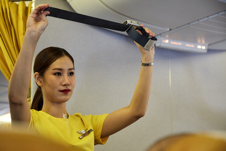 Bangkok Thailand, Jan 22 ,2019 , Airline nokscoot Interior of airplane with passengers on seats and stewardess in Yellow Flight attendant presenting a life vest on board before the flight departureのeditorial素材