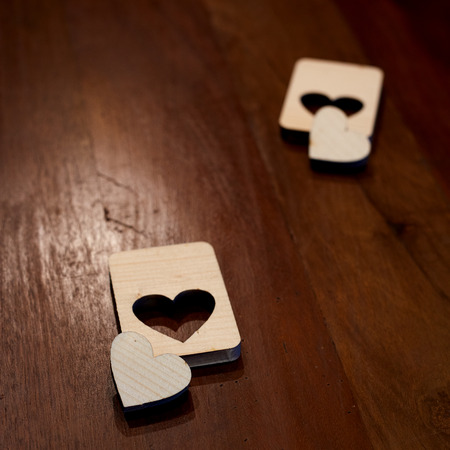 Two wooden hearts placed nicely on vintage wood background. Valentine's dayの写真素材