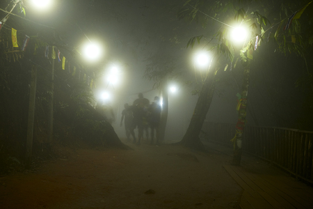 Chanthaburi, Thailand: Mar, 03,2019 , Foggy night People are worshiping the footprint in the rock on the top of Kitchakut Mountainのeditorial素材