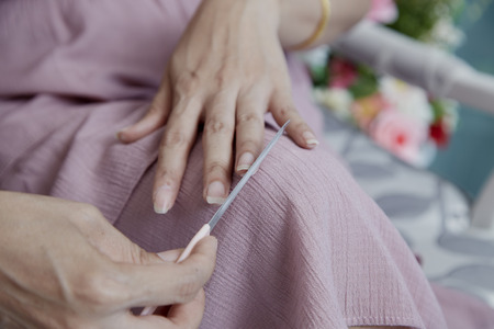 Close up photo of woman doing manicure with nail file, Body-care of hands.の写真素材