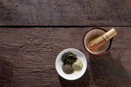Matcha fine powdered green tea on wooden