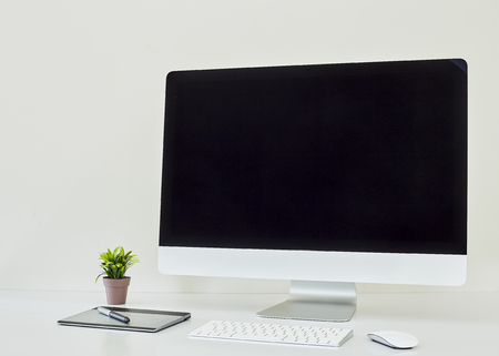 Computer display for mockup on working accessories on table and blank space fot textの写真素材