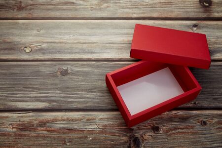 Empty red box on bright brown wood background, copy space for textの写真素材