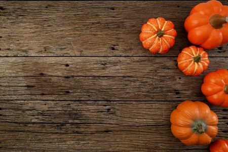 Pumpkins old brown wood table background with copy space, flat lay, minimal concept