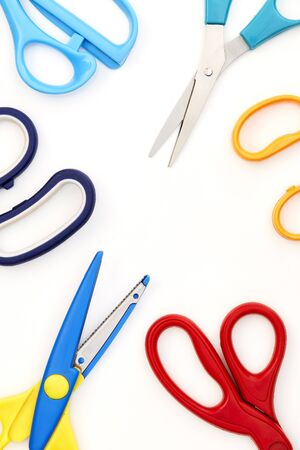 Flat lay composition with colorful scissors and school supplies on white background. Space for textの写真素材