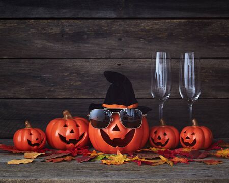 Happy Halloween pumpkin lantern. Trick or treat on a wooden table on a background of old wooden boards. Halloween background. Space for text.の写真素材