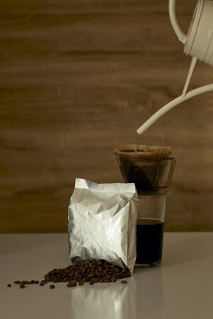 Coffe cup and mockup paper bag on wooden backgroundの写真素材