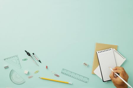 Creative arrangements of stationery on pastel pale blue background. Top view or flat lay. Education concept. Office desk with copy space.の写真素材