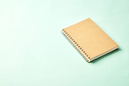 Notebook with pencil on pastel pale blue background, copy space for text with copy space, back to...