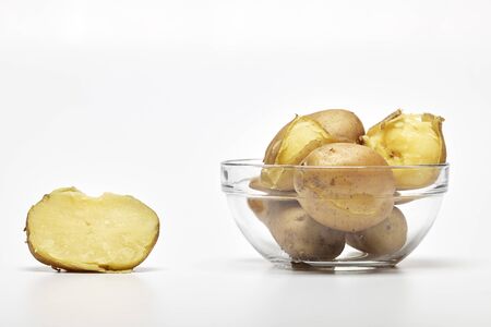 Boiled potatoes in a glass bowl on white backgroundの写真素材