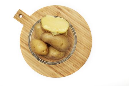 Boiled potatoes in a glass bowl on white backgroundの写真素材
