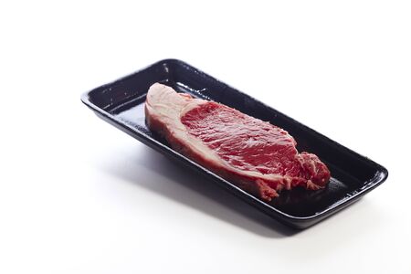 Raw beef steak in package isolated on white backgroundの写真素材