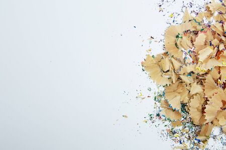 Shavings from multicolored pencils on white background, Education, Back to school Concept.の写真素材