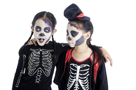 5-8 years Asian two children trick or treat, Asian Kids two with face-paint and Halloween costumes isolated in white backgroundの写真素材