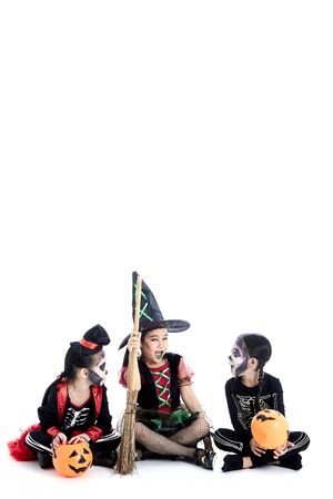 Group of asian Kids 5-8 years with face paint in wearing halloween costume on white backgroundの写真素材
