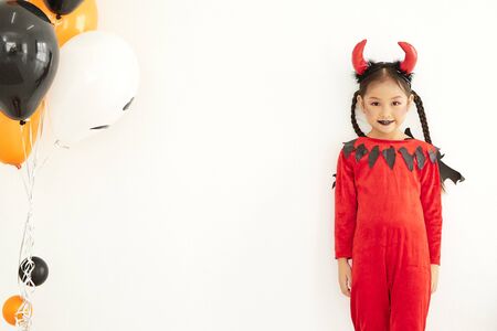 Happy Halloween Party children devil wearing with air balloons beautiful at home, Party girl cute...