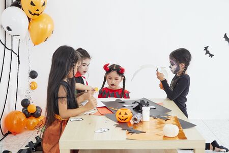 Happy Halloween, Group of asian children girls costumes Halloween party  have a fun, trick or treat at homeの写真素材