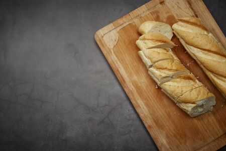 Bread cut slices for sandwiches on wooden chopping board table backgroundの写真素材