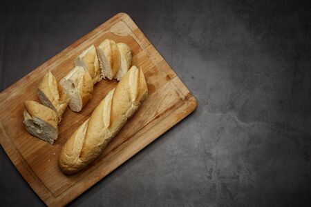 Bread cut slices for sandwiches on wooden chopping board table backgroundの写真素材