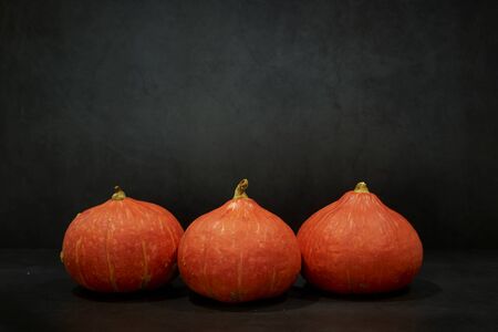 Three Pumpkins in black background texture dark shiny.  Halloween moodの写真素材