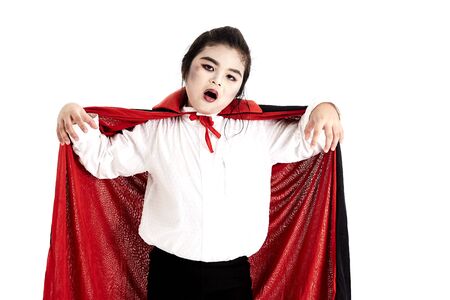 Little asian girl in halloween Scary Dracula costume on white backgroundの写真素材