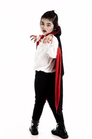 Little asian girl in halloween Scary Dracula costume on white backgroundの写真素材
