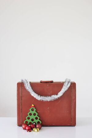 Vintage suitcase with Christmas decorations on white background. Christmas holiday conceptの写真素材