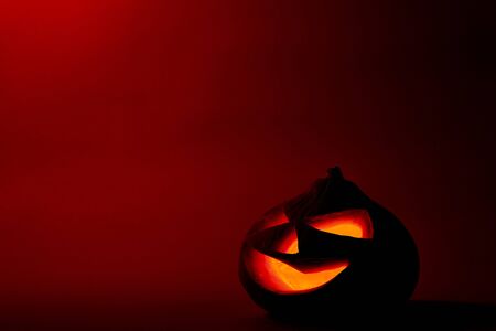 Halloween pumpkin head jack lantern with scary evil faces spooky holiday in the dark nightの写真素材