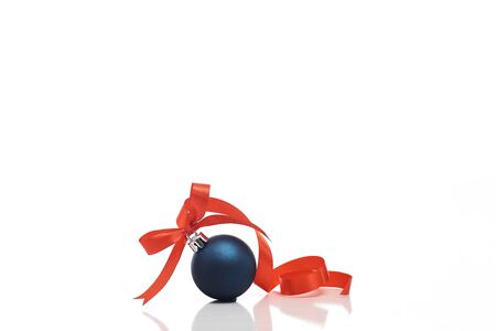 Blue christmas ball with red ribbon isolated on a white background. copy space for text. Winter decoration.の写真素材