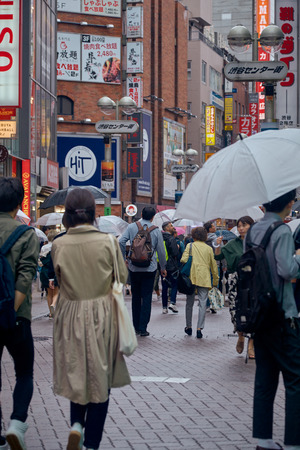 People in Hachiko Square, Shibuya shopping street on a rainy day, Shibuya is one of the most used pedestrians in the world.のeditorial素材
