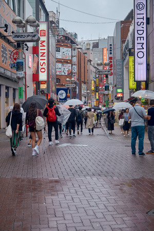 People in Hachiko Square, Shibuya shopping street on a rainy day, Shibuya is one of the most used pedestrians in the world.のeditorial素材