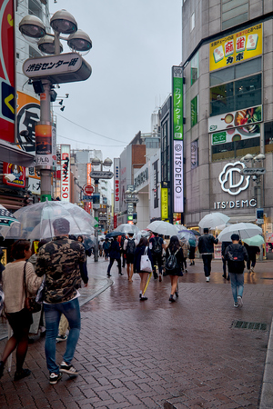 People in Hachiko Square, Shibuya shopping street on a rainy day, Shibuya is one of the most used pedestrians in the world.のeditorial素材