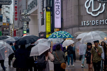 People in Hachiko Square, Shibuya shopping street on a rainy day, Shibuya is one of the most used pedestrians in the world.のeditorial素材