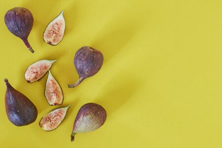 Fresh figs isolated on yellow background, copy space for text