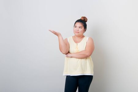 Portrait of Happy beautiful and healthy plump woman on Bright gray background, Diet control concepts For good healthの写真素材