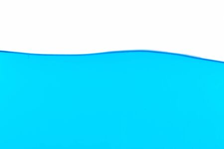 The surface of the blue water on white background, with space for textの写真素材