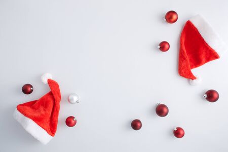 christmas flat lay. modern christmas layout with ornaments and  Christmas hat, top view with space for text. holiday mockup greeting card. stylish winter flatlayの写真素材