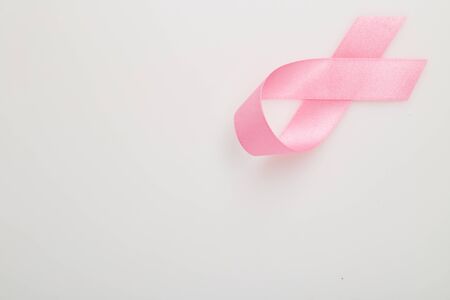 Pink breast cancer ribbon on white background, Concept World breast cancer day, flat lay copy space for textの写真素材