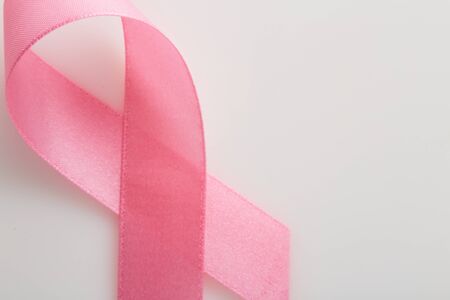 Pink breast cancer ribbon on white background, Concept World breast cancer day, flat lay copy space for textの写真素材