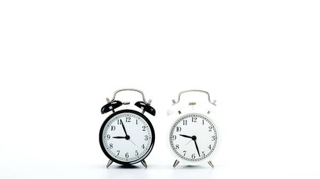 Black vintage alarm clock and White clock on white background  time sale  concept