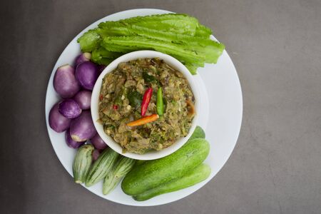 Thai food  Spicy vegetable salad In the bowl on the cooking tableの写真素材