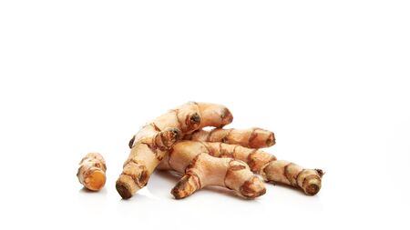 Asian herbs, Close up Fresh Turmeric Curcuma longa Linn, rhizome floor reflection isolated on white background, Food concept.の写真素材