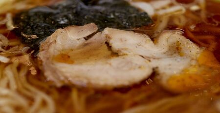 Traditional Japanese soup ramen with meat broth, asian noodles, seaweed, sliced pork. Background. Asian style food. Space for text. Hot tasty ramen soupの写真素材