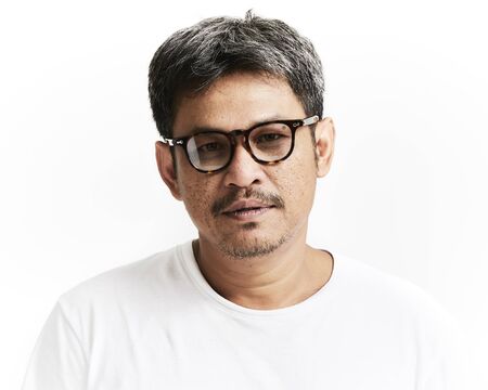 Portrait of smiling young man wearing t-shirt on white backgroundの写真素材